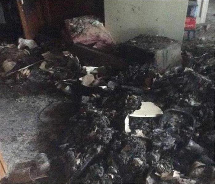 charred and blackened debris, insulation on floor of room