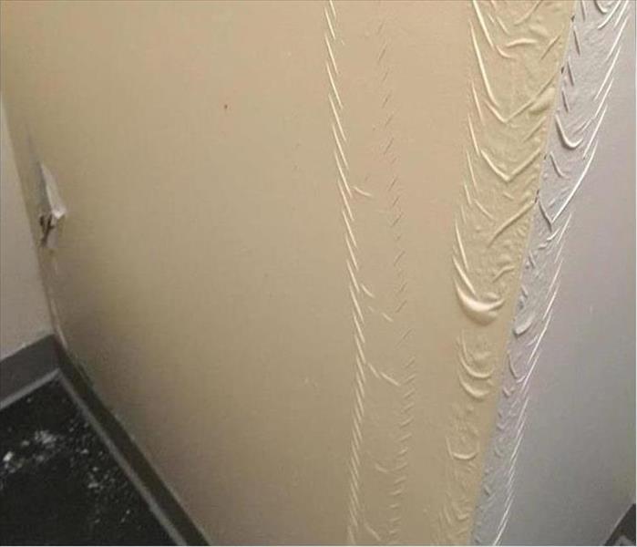 bubbling and damaged latex painted wall.
