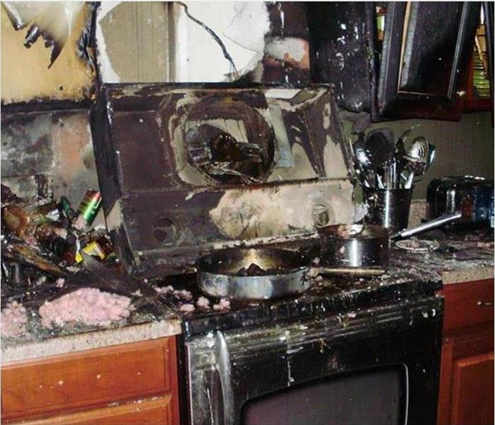 charred and damaged kitchen range and walls
