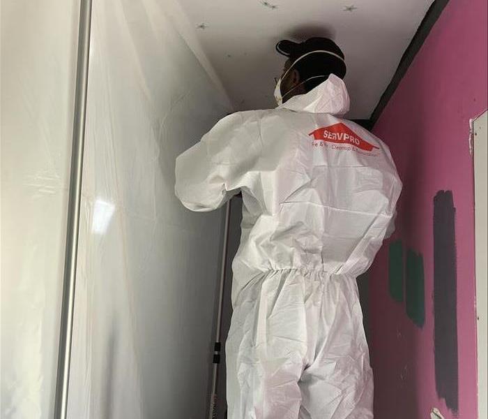 SERVPRO® crew member in PPE performing mold remediation work